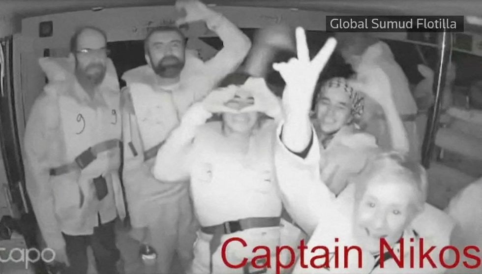 A screengrab from a live video footage shows people gesturing aboard the Gaza-bound Captain Nikos vessel,\u200b