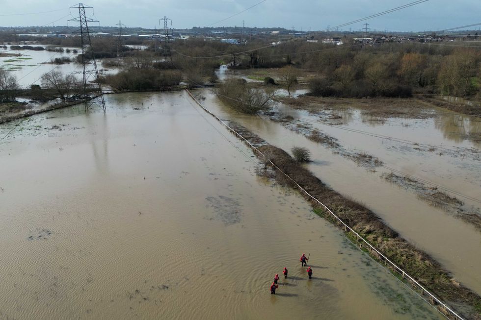 A search operation underway on flooded fields by the River Soar