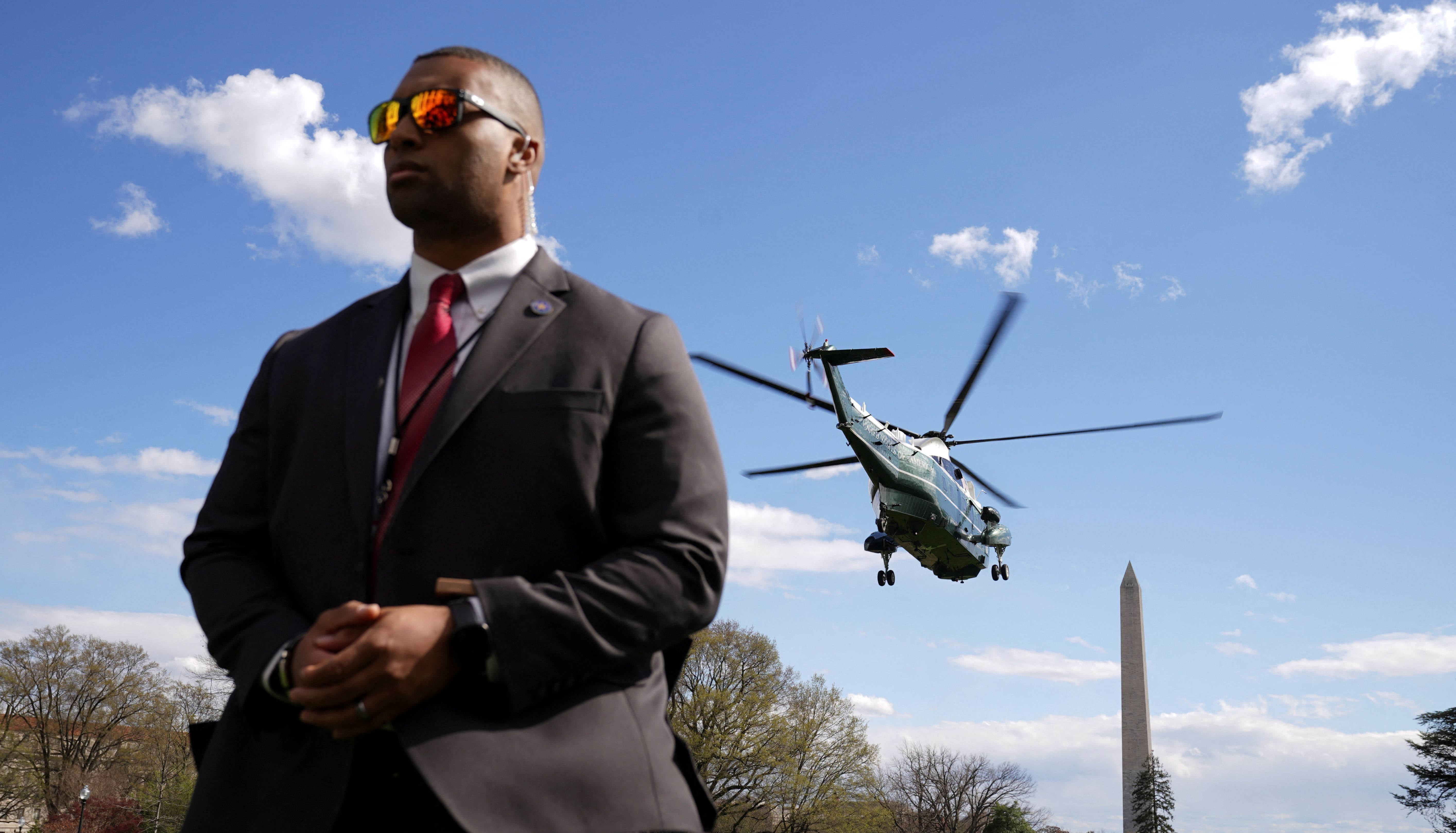 A Secret Service member keeps watch as U.S. President Joe Biden departs for Delaware aboard Marine One from the White House in Washington, U.S., April 1, 2022. REUTERS/Kevin Lamarque