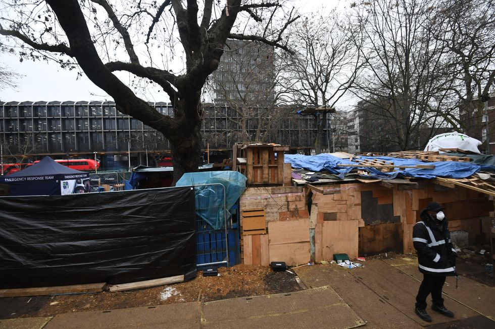 A security guard stands next to what remains of the anti-HS2 camp at Euston Square Gardens in February, 2021