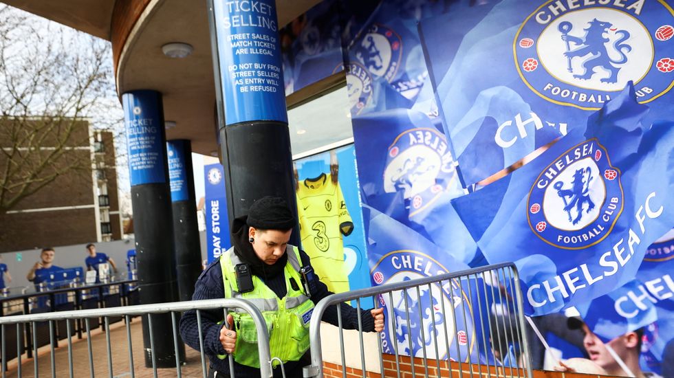 A security officer puts barricades outside Stamford Bridge, the stadium for Chelsea Football Club, after Britain imposed sanctions on its Russian owner, Roman Abramovich, in London, Britain, March 10, 2022. REUTERS/Hannah Mckay