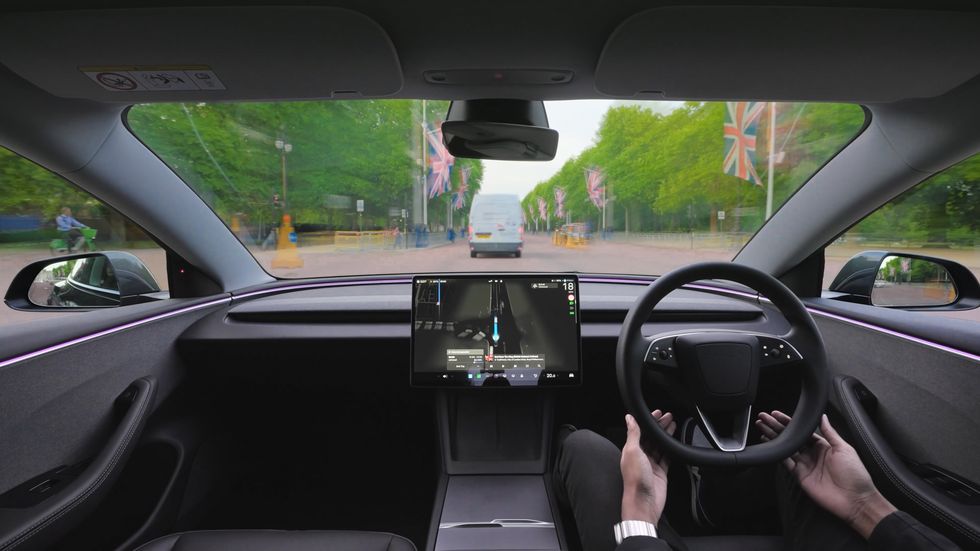 A self-driving Tesla in front of Buckingham Palace
