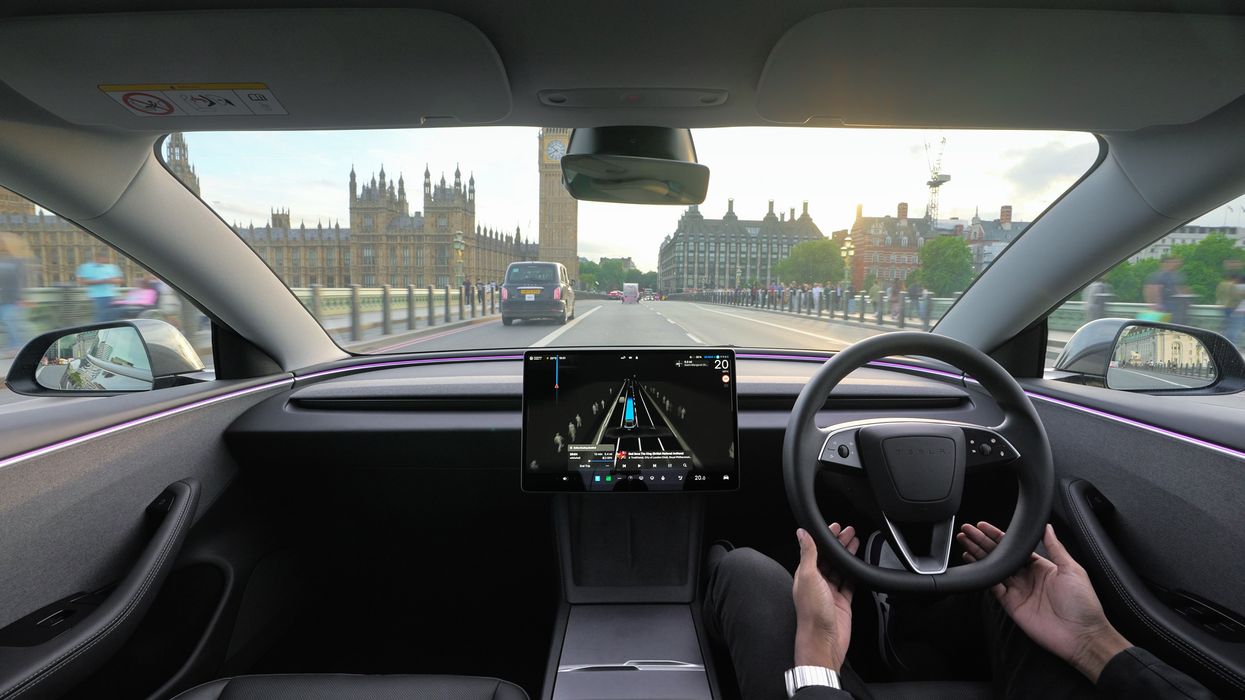 A self-driving Tesla in front of the Houses of Parliament in London