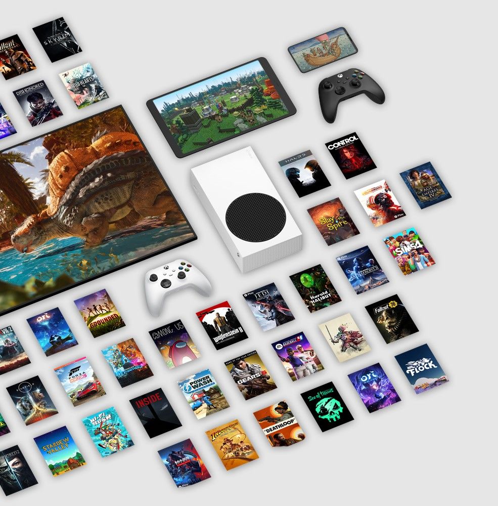 a series of xbox games box art on the ground with an xbox series s in the centre