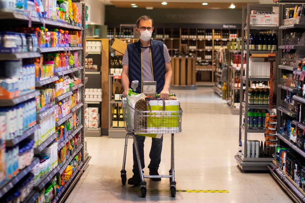 A shopper wearing a face mask in a supermarket