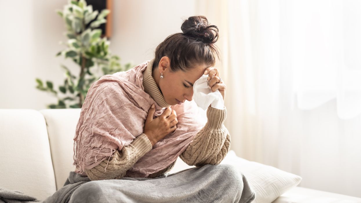A sick woman with her hand on her forehead