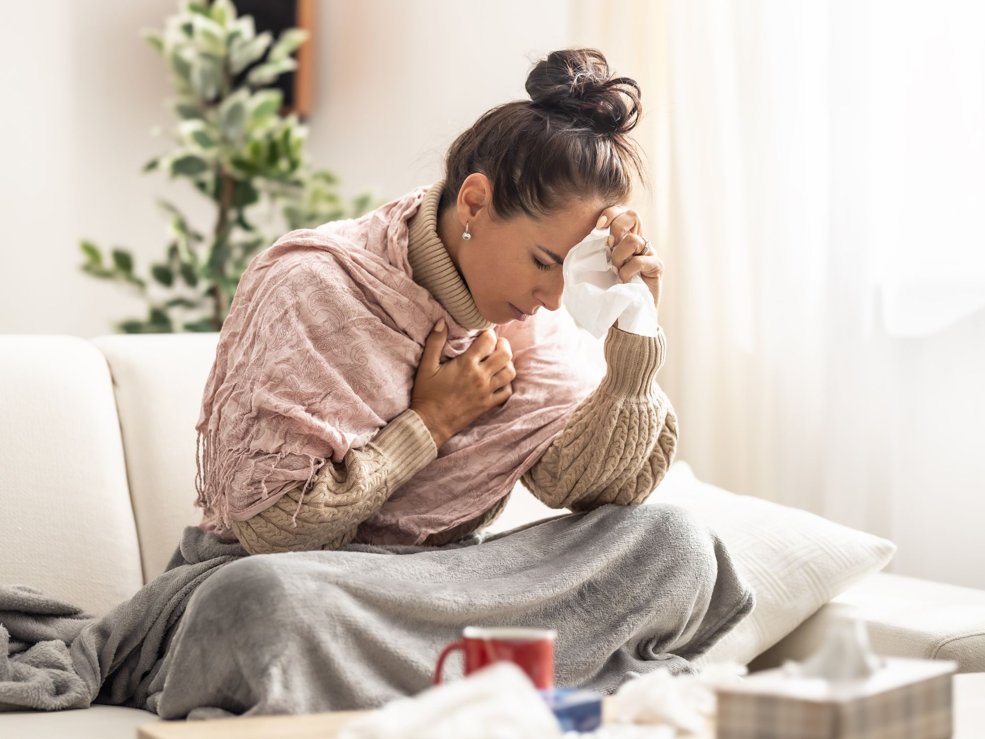 A sick woman with her hand on her forehead