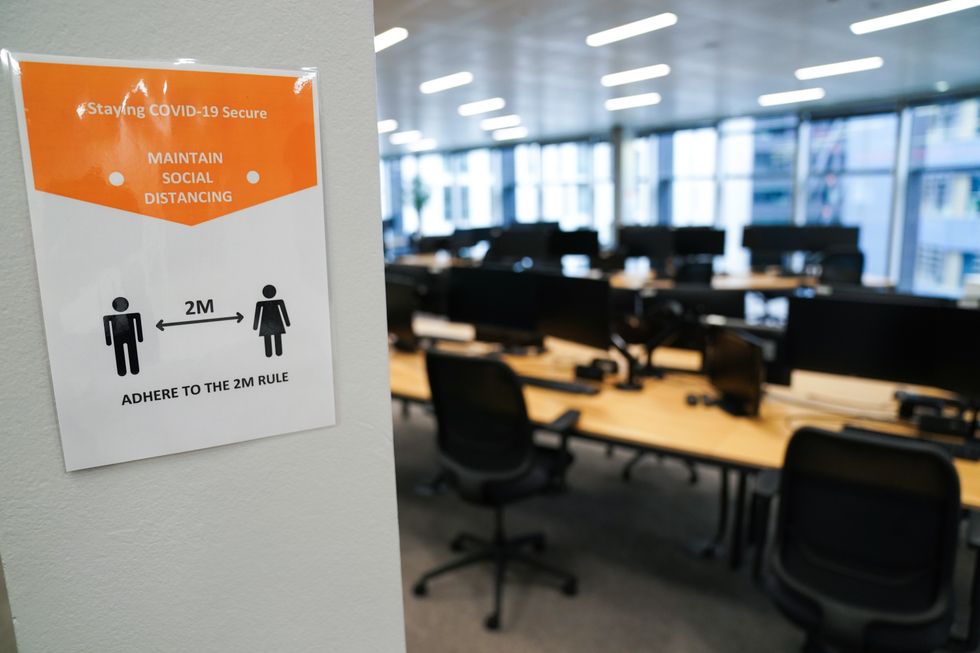 A sign giving guidance on social distancing in an empty office in central London. Picture date: Monday January 3, 2022.