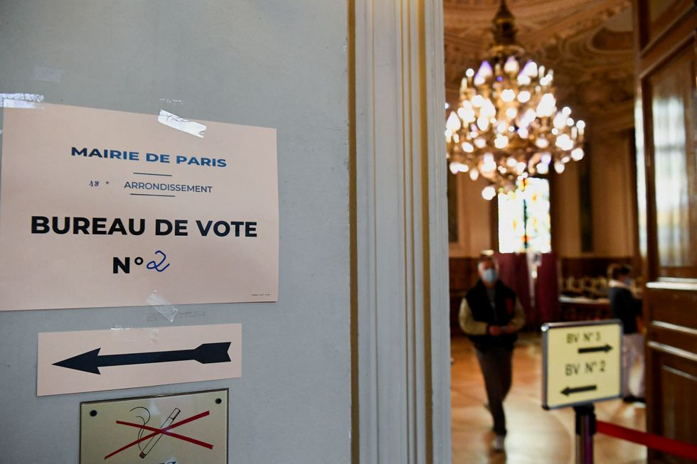 A sign is seen at a polling station in the second round of the 2022 French presidential election in Paris, France, April 24, 2022. REUTERS/Piroschka Van De Wouw