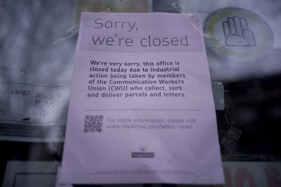 A sign on a door advising of closures due to industrial action from the Communication Workers Union (CWU) at the Camden Town Delivery Office in north west London. Members of the Communication Workers Union (CWU) are holding a 48-hour strike in a long-running dispute over jobs, pay and conditions. Picture date: Thursday November 24, 2022.