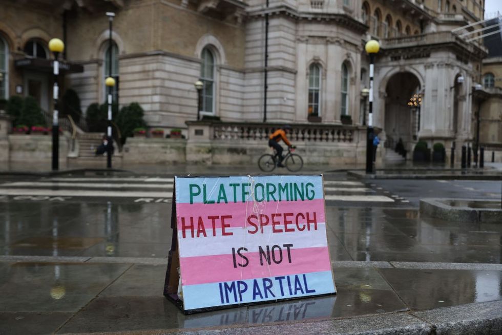 A sign reading "platforming hate speech is not impartial"