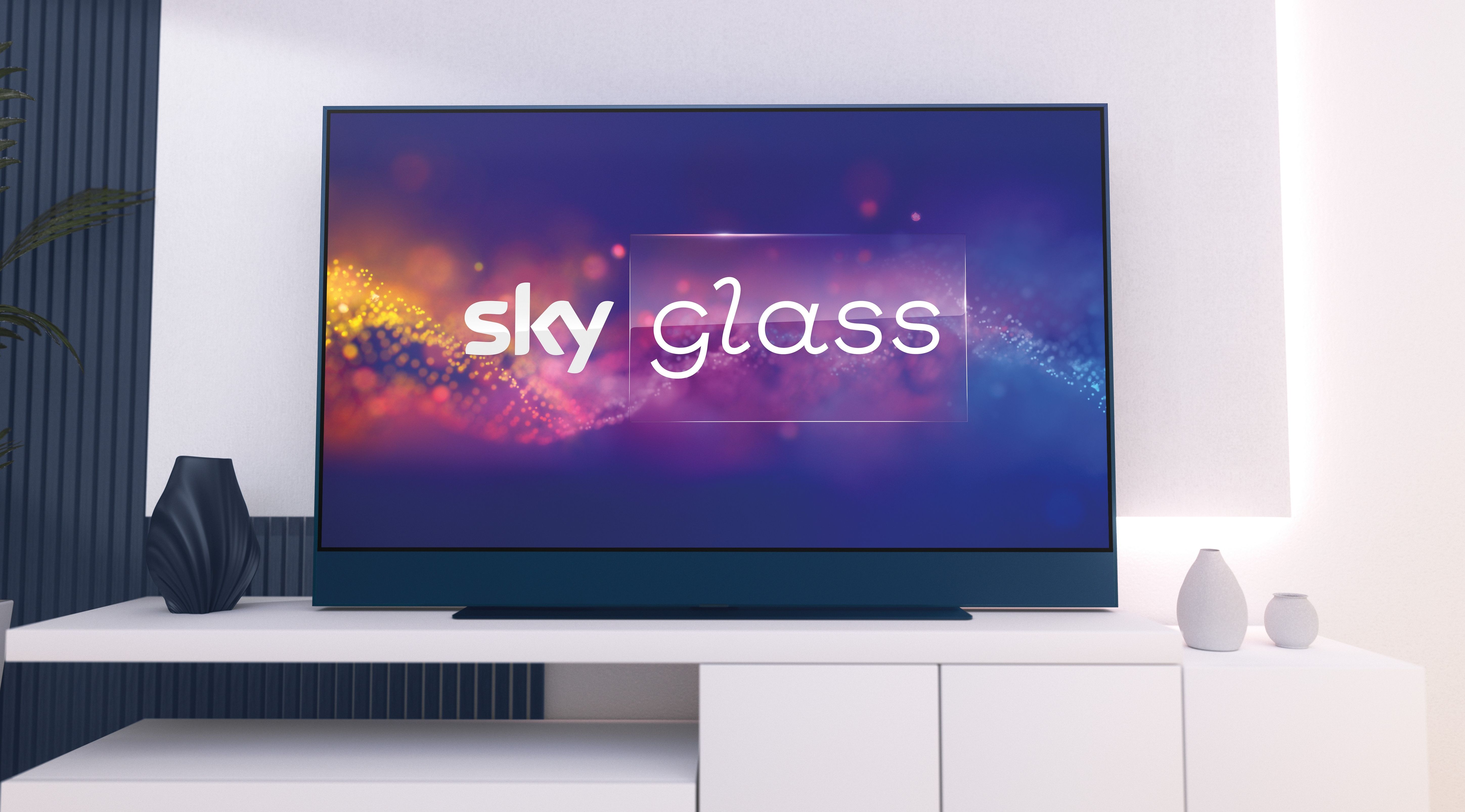 a sky glass tv is pictured on a sideboard in a home