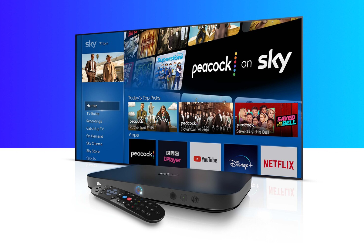 a sky q box and remote control are pictured in front of a large flatscreen tv with Peacock shows 