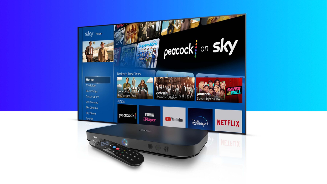 a sky q box and remote control are pictured in front of a large flatscreen tv with Peacock shows