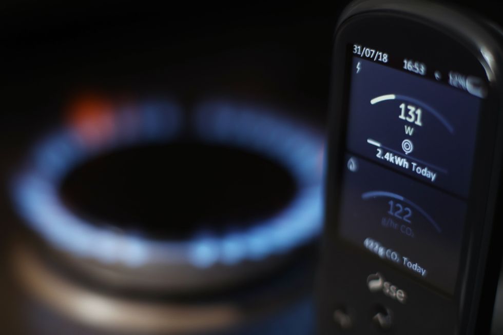 a smart meter pictured in front of a gas hob