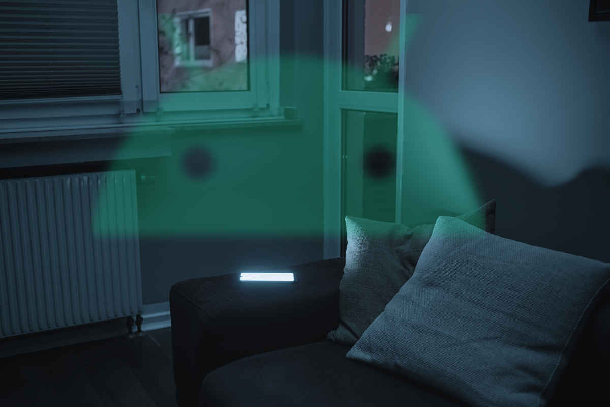 a smartphone screen illuminates a darkened room with an android logo superimposed 