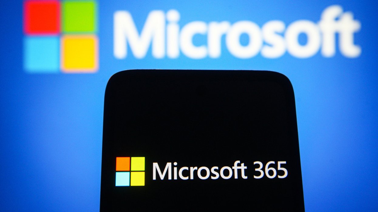a smartphone with the microsoft 365 logo in front of a blue background