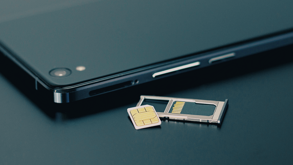 a smartphone with the physical SIM card tray removed