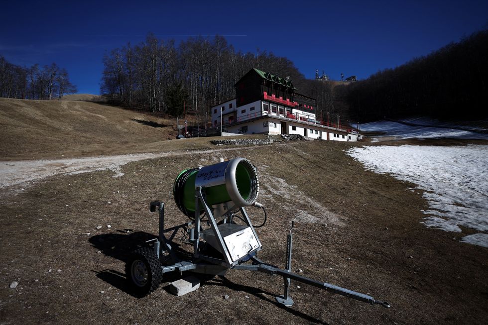 A snow cannon on a grassy slope