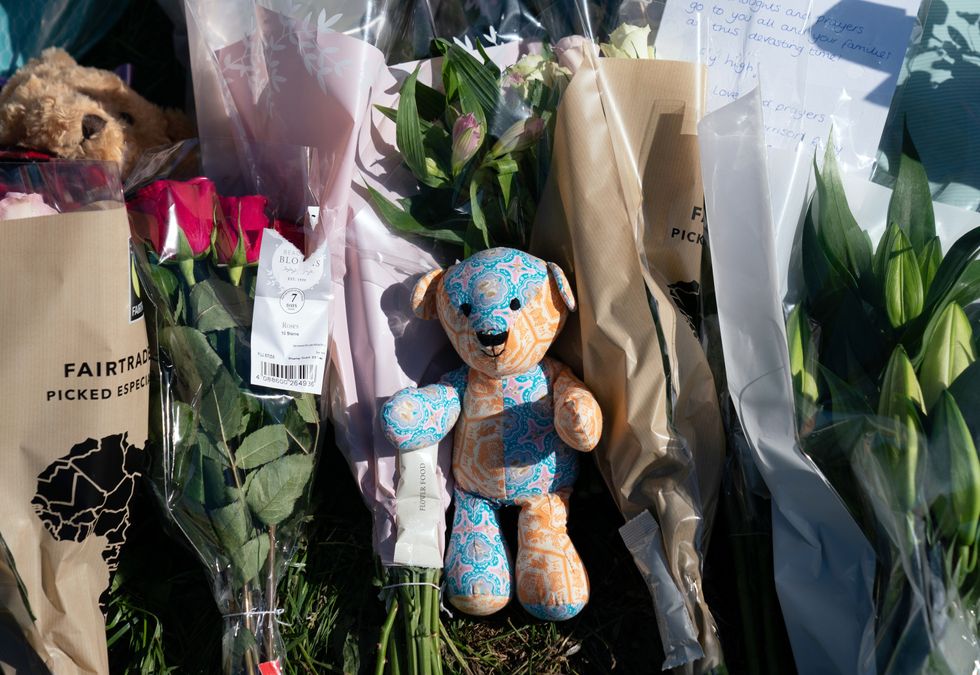 A soft toy is left among floral tributes at the scene in Chandos Crescent in Killamarsh