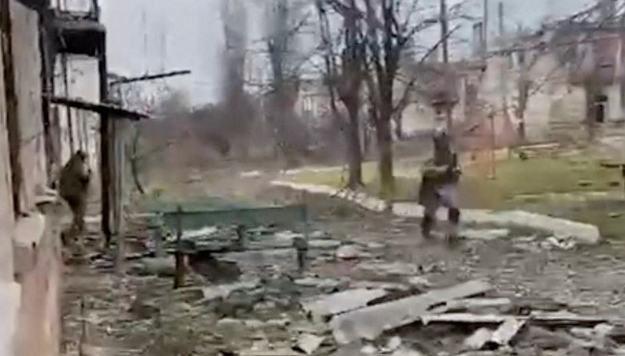 A soldier runs through debris of damaged buildings in location said to be Soledar, Ukraine in this still image obtained from a video released January 12, 2023. Courtesy of State Border Guard Service of Ukraine/Handout via REUTERS  THIS IMAGE HAS BEEN SUPPLIED BY A THIRD PARTY. MANDATORY CREDIT. NO RESALES. NO ARCHIVES. REUTERS WAS NOT ABLE TO CONFIRM THE LOCATION OF THE VIDEO OR THE DATE IT WAS FILMED.