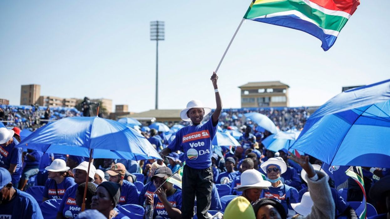 A South African main opposition Democratic Alliance (DA) supporter waves a South African flag