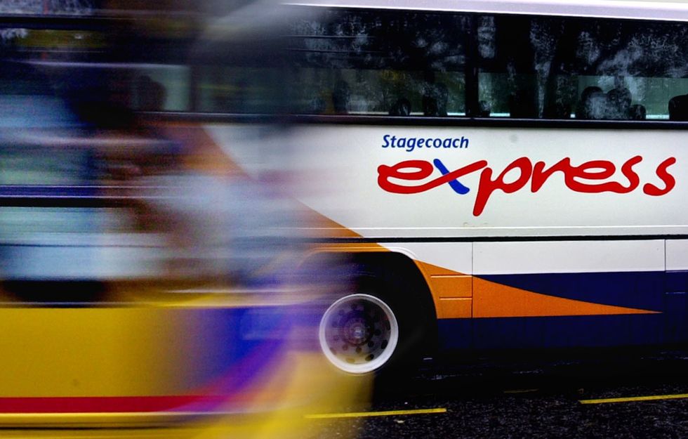 A 'Stagecoach Express' coach passes by on a rainy day in Edinburgh, Scotland