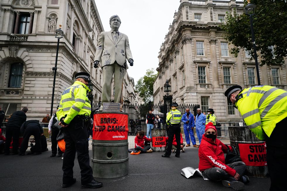 A statue of Prime Minister Boris Johnson splattered with oil as campaigners from Greenpeace demonstrate Downing Street, London, against the Cambo oil field off the west coast of Shetland.