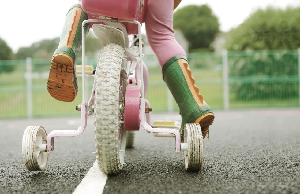 A stock image of a child riding a bicycle