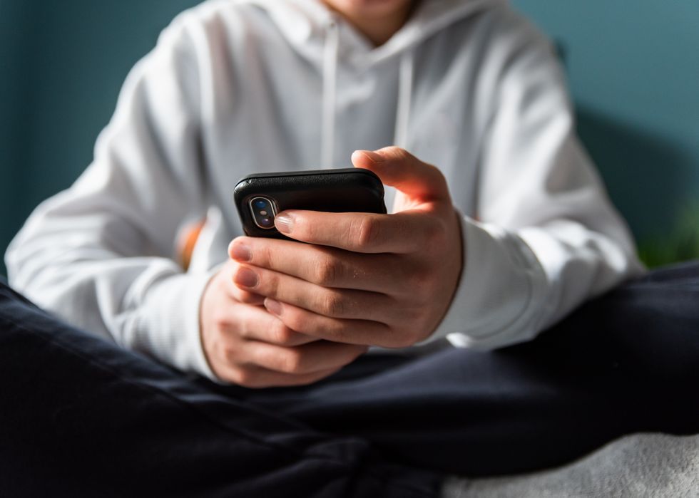 A stock image of a child using a phone