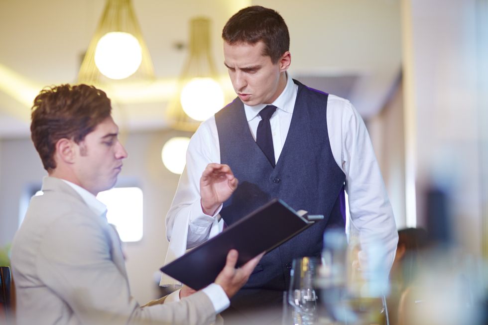 A stock image of a man ordering food at a restaurant