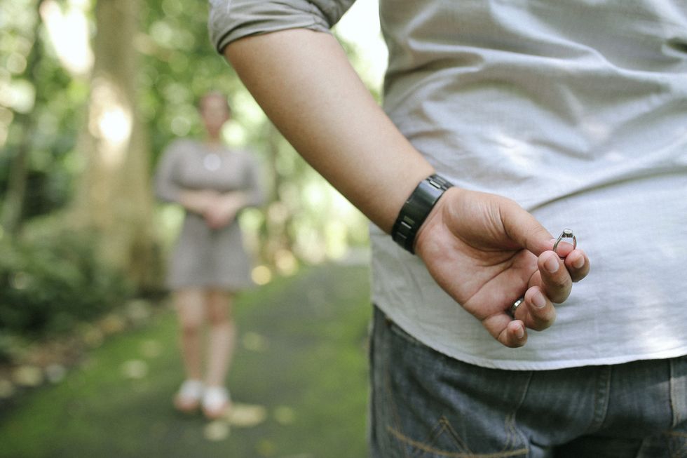 A stock image of a man preparing to propose to his partner