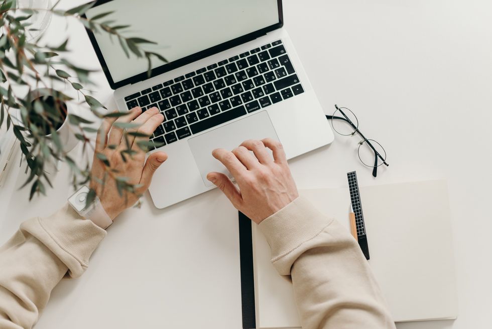 A stock image of a man typing on a laptop