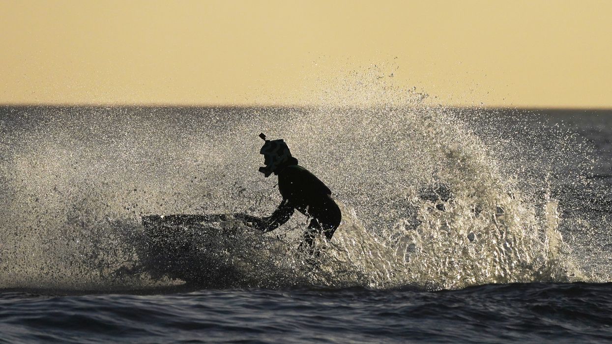 A stock image of a person riding a jet ski