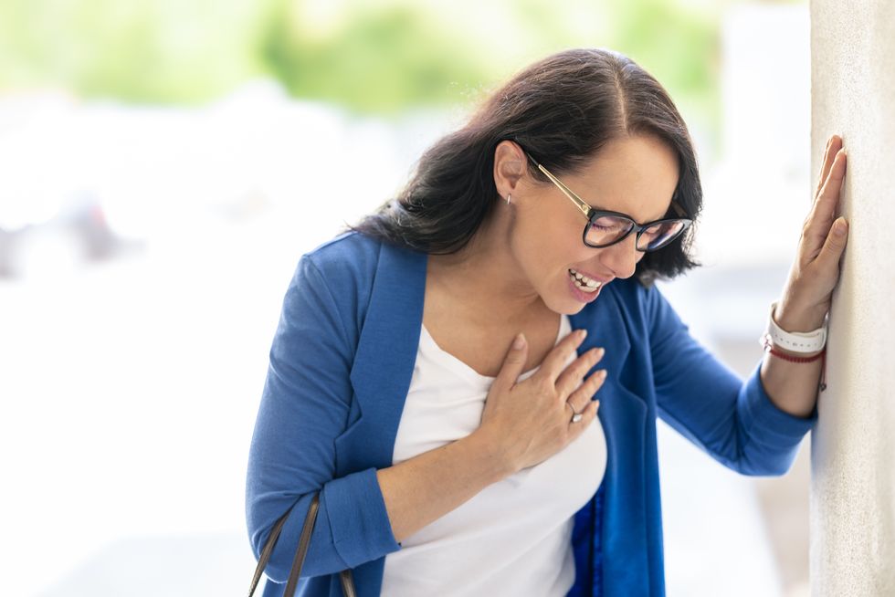 A stock image of a woman suffering from a heart attack