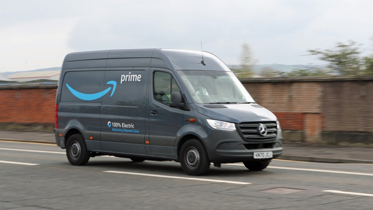 A stock image of an Amazon delivery driver