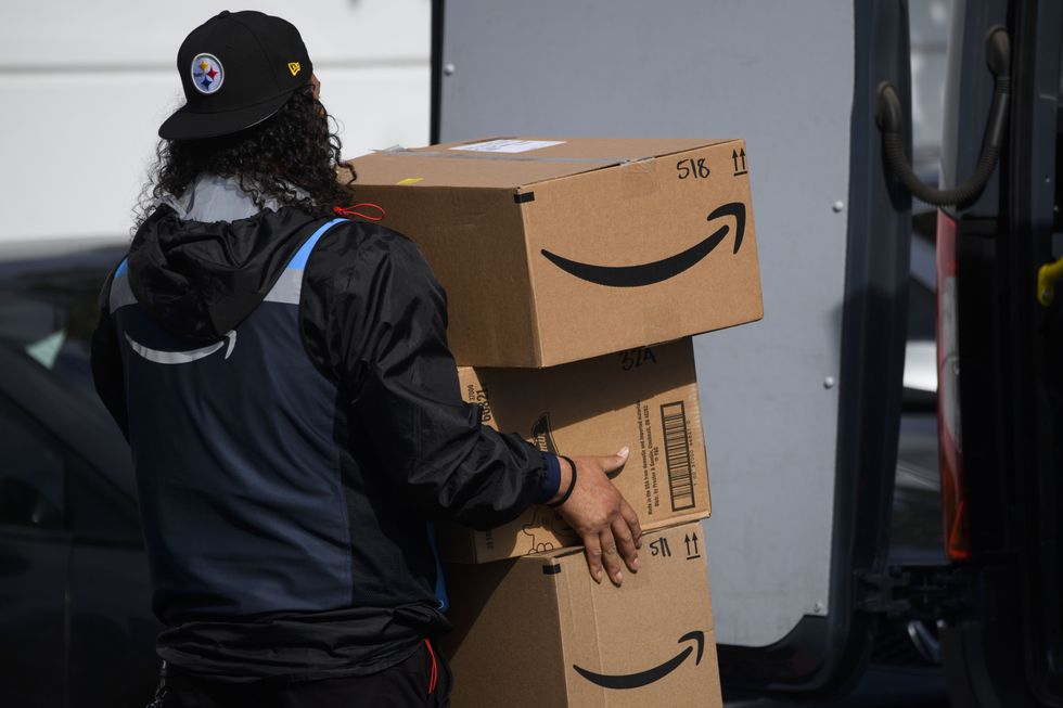A stock image of an Amazon delivery driver