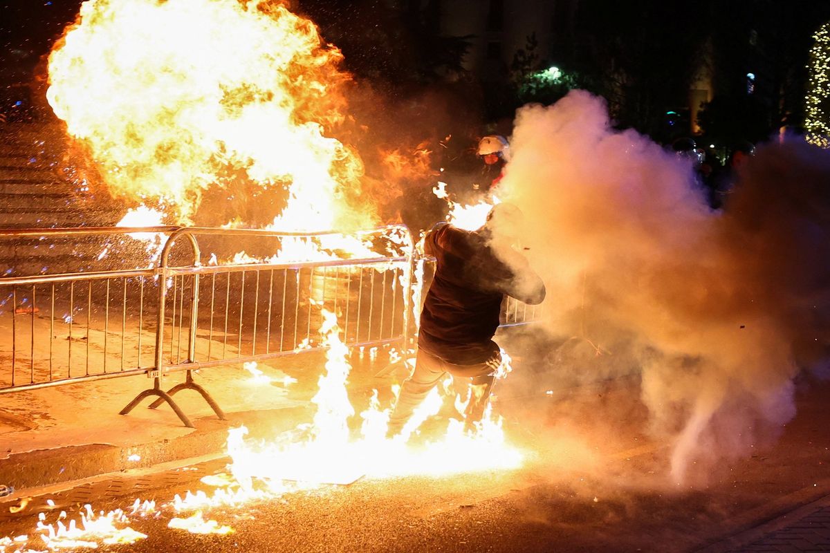 A supporter of the opposition is burned by a Molotov cocktail