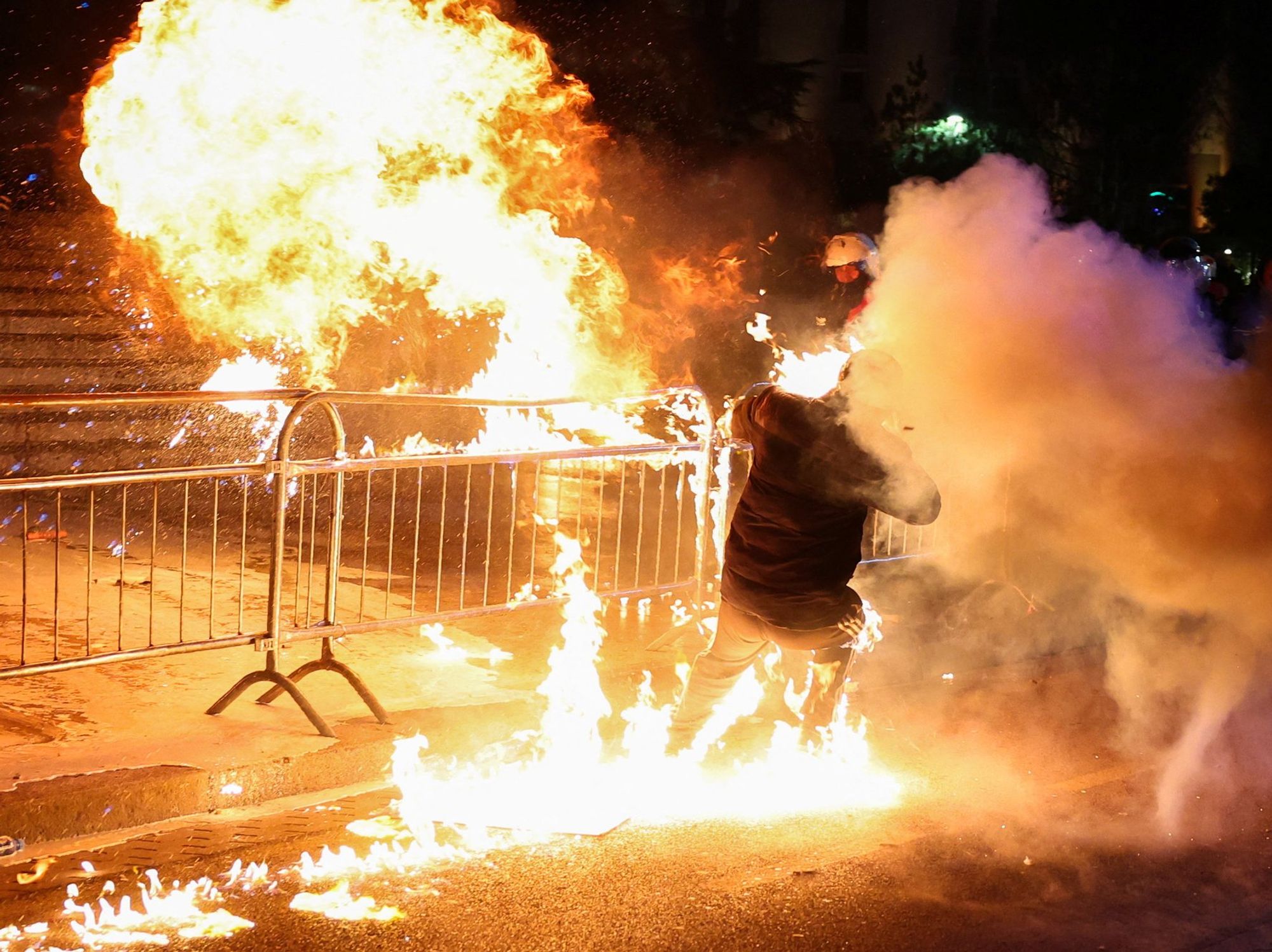 A supporter of the opposition is burned by a Molotov cocktail