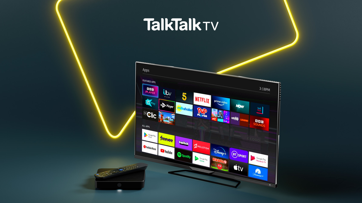 a talktalk tv hub is pictured with the remote laying on top in front of a flatscreen tv running the latest version of the talktalk tv software