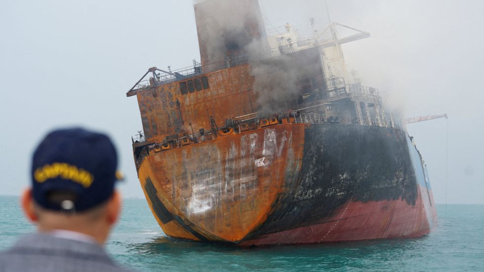 A tanker carrying Iraqi oil lists in the water after catching fire off the coast of Iraq