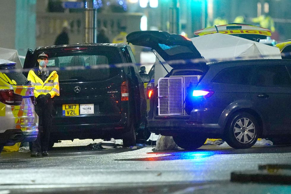 A taxi and a police tent erected in the middle of a cordon in Kensington High Street, London, where a man died after sustaining gunshot wounds in an incident involving armed officers close to Kensington Palace. Picture date: Saturday December 11, 2021.