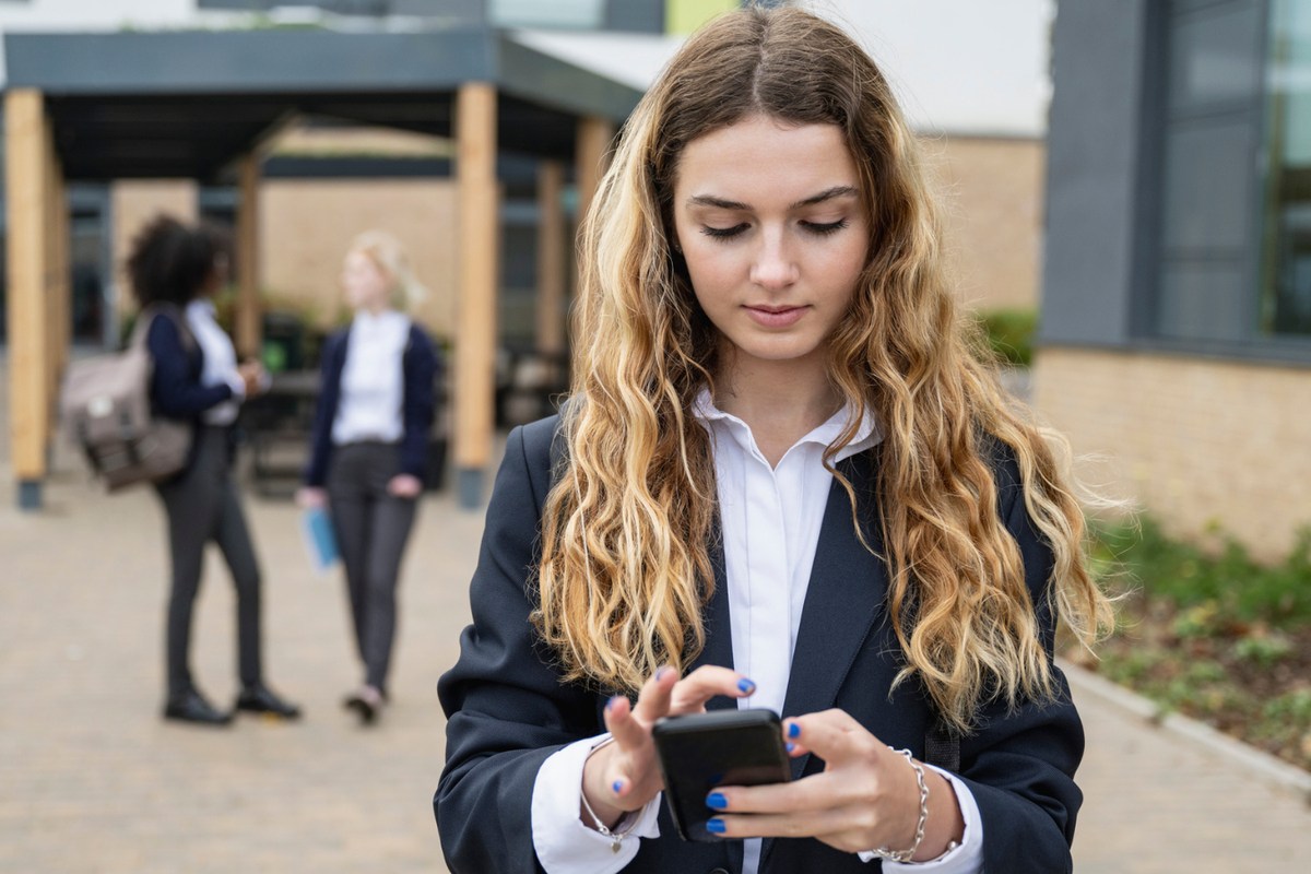 A teenager looking at her phone