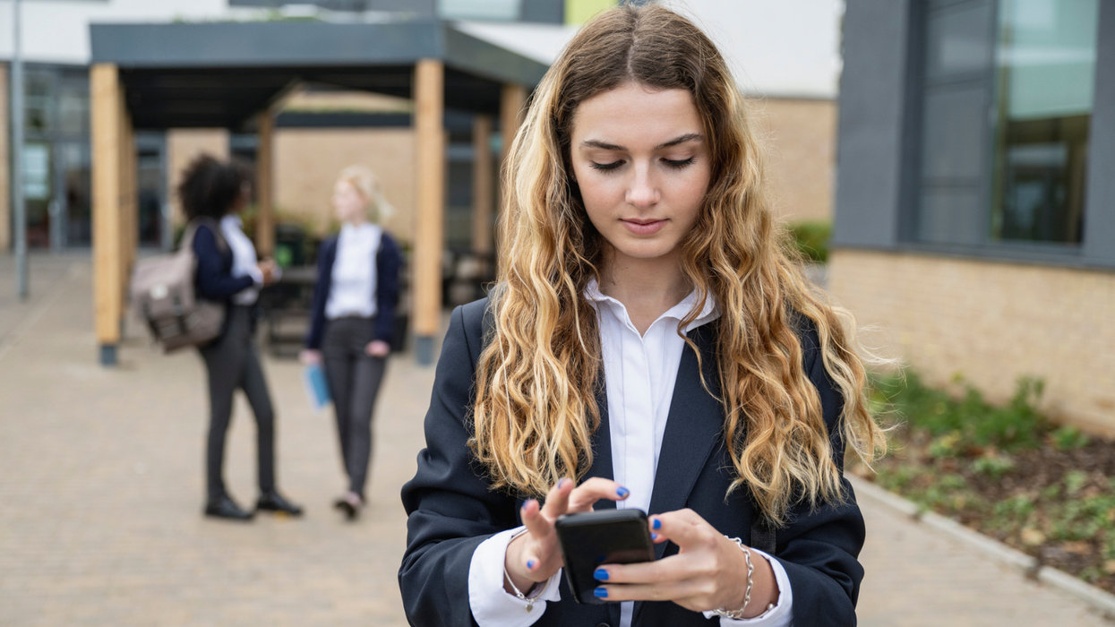 A teenager looking at her phone