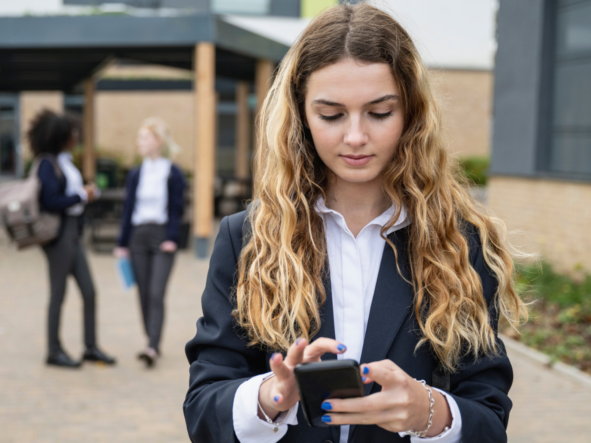 A teenager looking at her phone