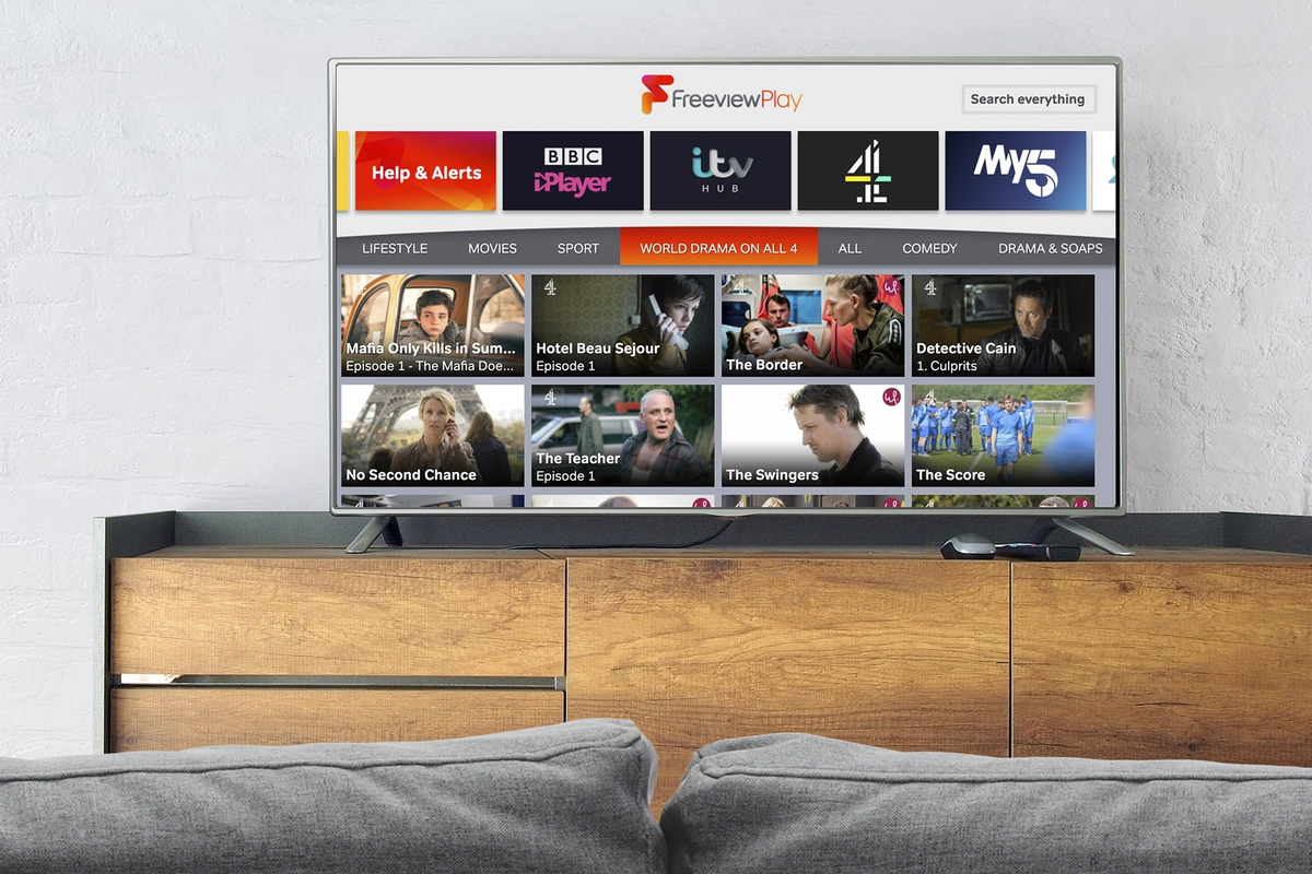 a television with the freeview play menu sits on a chest of drawers
