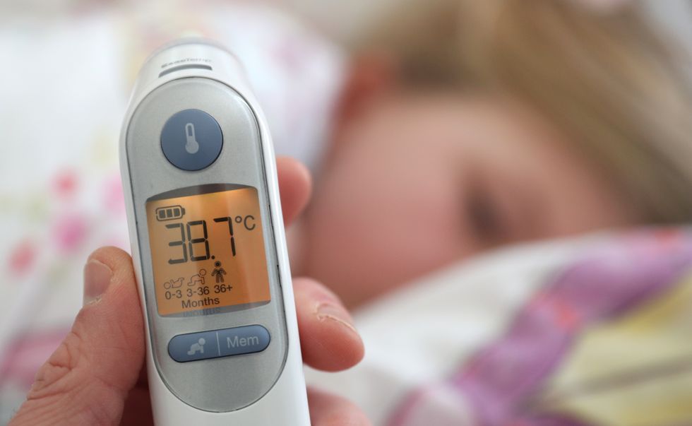 A temperature of 38.7 degrees is visible on a digital ear thermometer after being taken from a poorly 5 year old girl. PA Photo. Picture date: Monday March 23, 2020. Photo credit should read: Andrew Matthews/PA Wire