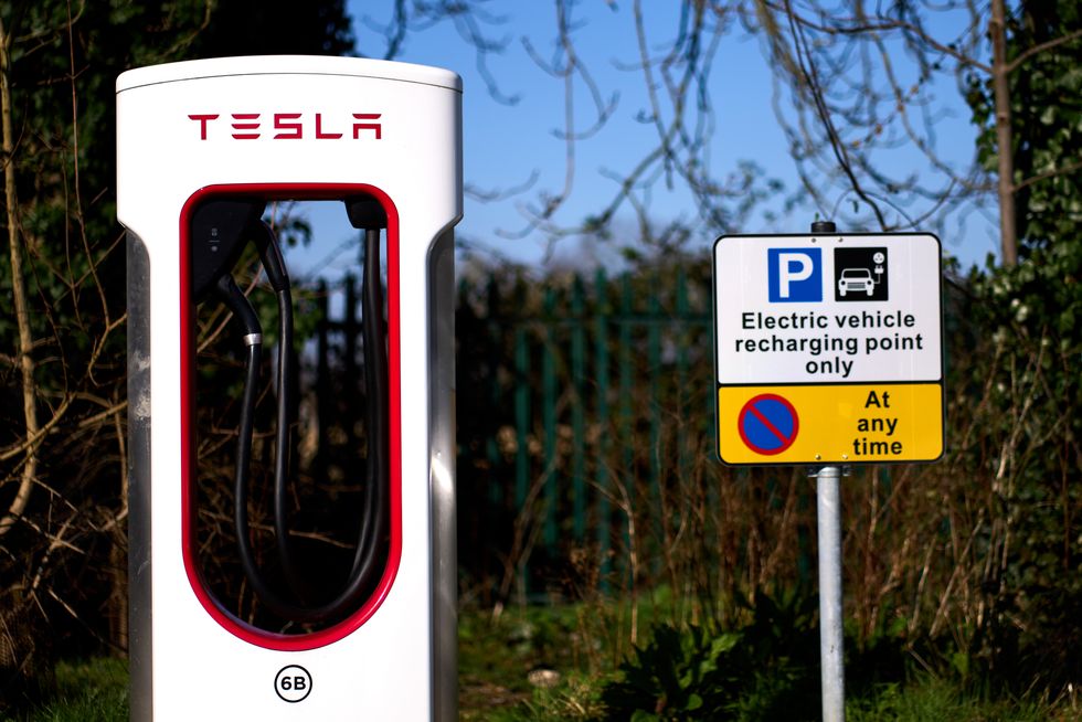 A Tesla supercharger point and electric vehicle recharging point sign in London. Picture date: Monday March 7, 2022.