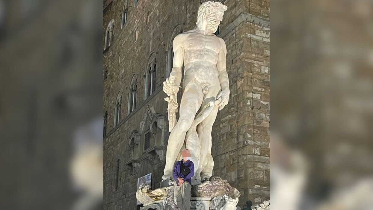 A tourist who climbed onto a Renaissance statue of the god Neptune in Florence