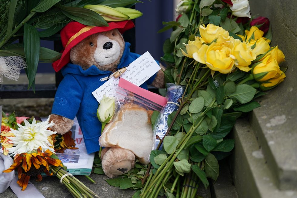 A toy Paddington Bear and a marmalade sandwich, a nod to the Queen's association with the children's book character at the Royal Jubilee, laid outside the Palace of Holyroodhouse in Edinburgh. Queen Elizabeth II's coffin is travelling from Balmoral to Edinburgh, where it will lie at rest at the Palace of Holyroodhouse. Picture date: Sunday September 11, 2022.